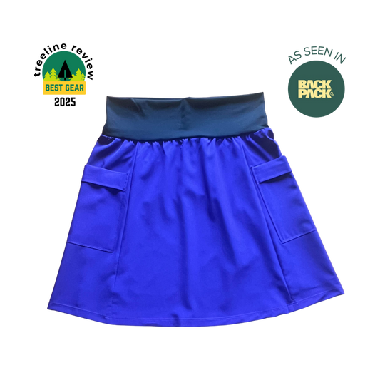 Blue skirt with pockets on a white background, featuring 'TreeLine Review' and 'Back Pack' logos.