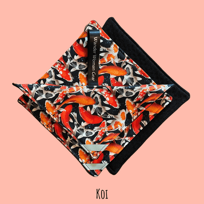 Koi fish patterned pouch with black border on a pink background