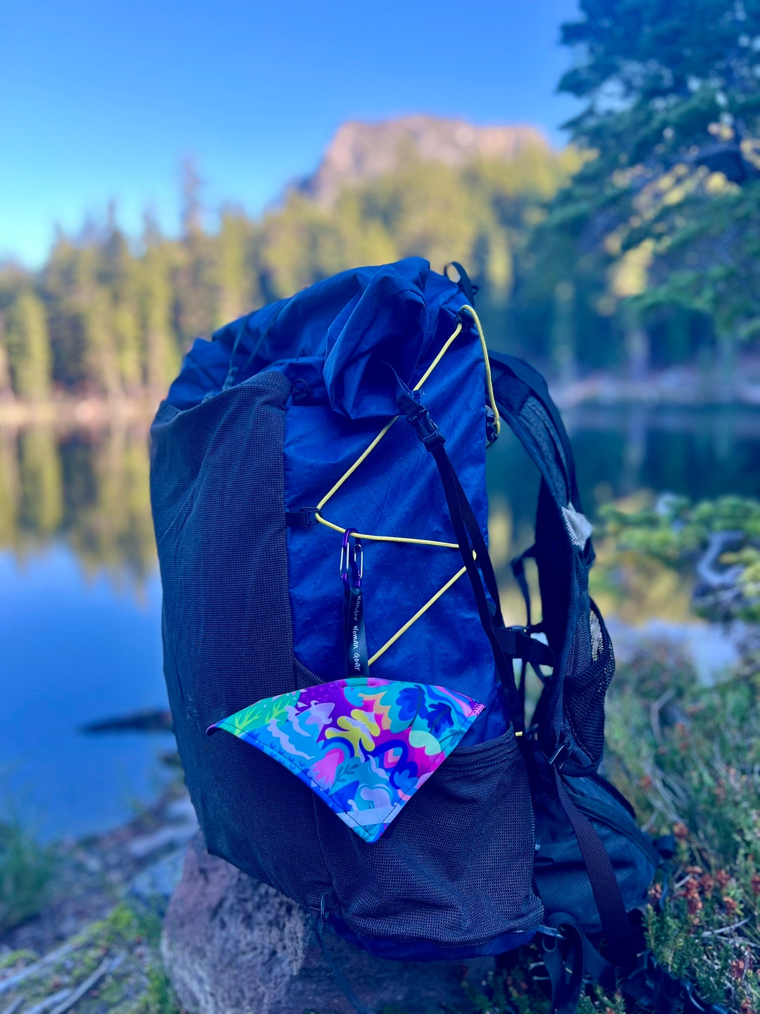 Colorful pee cloth attached to a backpack outdoors