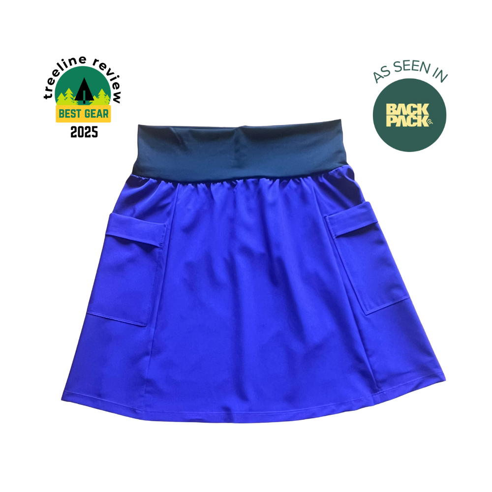 Blue skirt with pockets on a white background, featuring 'TreeLine Review' and 'Back Pack' logos.