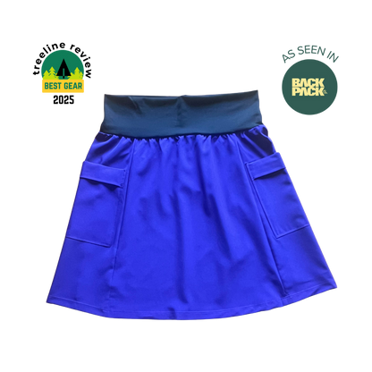 Blue skirt with pockets on a white background, featuring 'TreeLine Review' and 'Back Pack' logos.